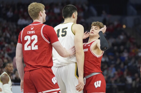 Purdue center Zach Edey (15) and Wisconsin guard Max Klesmit, right, get into an altercation during the first half of an NCAA college basketball game in the semifinal round of the Big Ten Conference tournament, Saturday, March 16, 2024, in Minneapolis. (AP Photo/Abbie Parr)