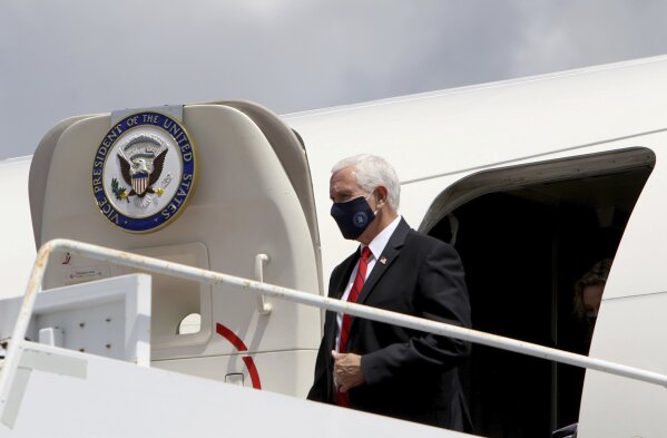 Vice President Mike Pence emerges from Air Force Two after arriving at Tampa Airport on Wednesday Aug. 5, 2020, with plans to visit the Hilton Clearwater Beach Resort & Spa in Clearwater as part of his 'Faith in America' tour. (Douglas R. Clifford/Tampa Bay Times via AP)