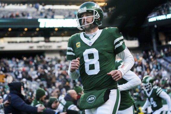 New York Jets quarterback Aaron Rodgers runs onto the field before an NFL football game against the Miami Dolphins, Sunday, Jan. 5, 2025, in East Rutherford, N.J. (AP Photo/Seth Wenig, File)