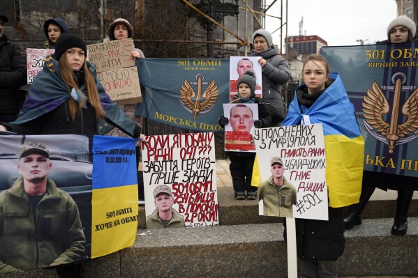 People attend a rally to demand the release of Ukrainian prisoners of war, who were taken captive in the Mariupol region of Ukraine by Russian forces, in Kyiv, Ukraine, Saturday, Feb. 24, 2024. Ukraine is marking two years since Russia's full-scale invasion with a somber mood hanging over the country. On the battlefield, Ukrainian troops are running low on ammunition as they hope for further Western aid. (AP Photo/Evgeniy Maloletka)
