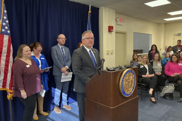 Kentucky state Sen. Danny Carroll unveils details of his bill to shore up and expand access to childcare in Kentucky on Tuesday, Feb. 13, 2024, in Frankfort, Ky. Carroll's bill also aims to bolster early childhood education in the state. (AP Photo/Bruce Schreiner)