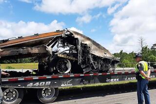 Some of the wreckage from a fatal multiple-vehicle crash a day earlier is loaded to be carried away, Sunday, June 20, 2021, in Butler County, Ala. (Lawrence Specker/Press-Register/AL.com via AP)
