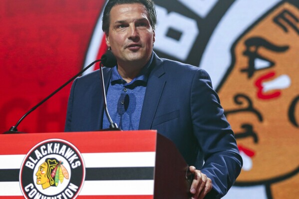 FILE - Former Chicago Blackhawks player Eddie Olczyk speaks during the NHL hockey team's convention in Chicago, July 26, 2019. During last year’s Kentucky Derby, Olczyk did what every horse racing fan and handicapper has done at one point — he changed his pick and ended up regretting it. The major difference though is that Olczyk’s flip happened when nearly 15 million people were watching. (AP Photo/Amr Alfiky, File)