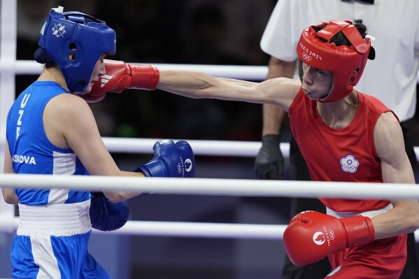 Taiwan's Lin Yu-ting hits Uzbekistan's Sitora Turdibekova in their women's 57 kg preliminary boxing match at the 2024 Summer Olympics, Friday, Aug. 2, 2024, in Paris, France. (AP Photo/John Locher)