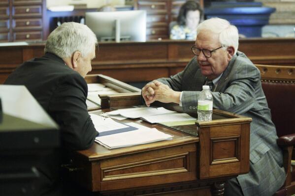 Kansas Senate Majority Leader Larry Alley, left, R-Winfield, confers with Senate Vice President Rick Wilborn, R-McPherson, shortly before the Senate adjourns for the year, Friday, April 28, 2023, at the Statehouse in Topeka, Kan. No big tax cuts are coming for Kansas residents even though the state treasury is bulging with surplus cash. (AP Photo/John Hanna)