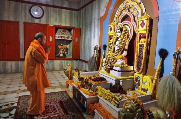 Uttar Pradesh Chief Minister Yogi Adityanath prays at a temple in the morning before going to file his nomination papers for the state assembly elections in Gorakhpur, India, Feb. 5, 2022. The polls are a referendum on the saffron-robed Adityanath, a poster figure for the Hindu right-wing, who some analysts believe is vying to be the next prime minister. Over 150 million people are expected to vote in the state across seven phases starting Thursday before results are declared in March. (AP Photo/Rajesh Kumar Singh)