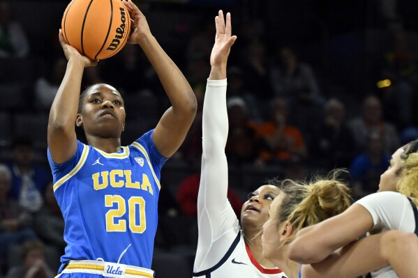 FILE - UCLA guard Charisma Osborne (20) shoots against Arizona during the first half of an NCAA college basketball game in the quarterfinal round of the Pac-12 women's tournament March 2, 2023, in Las Vegas. UCLA got a boost when leading scorer and rebounder Osborne decided to use her extra COVID-19 year of eligibility. Her 52 steals were a single-season career high. (AP Photo/David Becker, File)