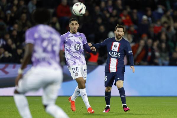 PSG's Lionel Messi, right, eyes the ball next to Toulouse's Fares Chaibi during the French League One soccer match between Paris Saint-Germain and Toulouse, at the Parc des Princes, in Paris, France, Saturday, Feb. 4, 2023. (AP Photo/Lewis Joly)