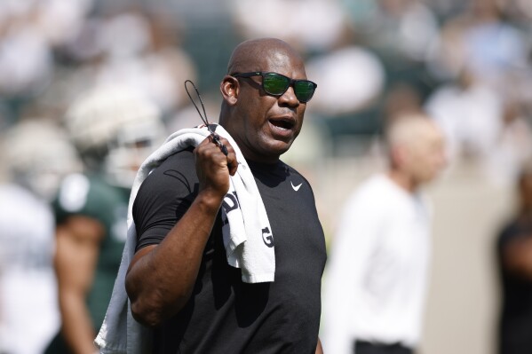 FILE - Michigan State coach Mel Tucker watches during an NCAA college football scrimmage, Saturday, April 15, 2023, in East Lansing, Mich. Michigan State athletic director Alan Haller has informed suspended football coach Mel Tucker he is being fired for cause without compensation for his conduct with activist and rape survivor Brenda Tracy. “The notice provides Tucker with seven calendar days to respond and present reasons to me and the interim president as to why he should not be terminated for cause,” Haller said in a statement sent by the school on Monday, Sept. 18. (AP Photo/Al Goldis)