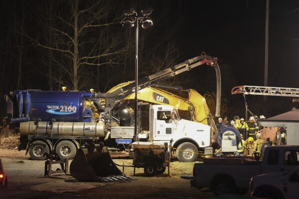 Rescue workers search in a sinkhole for Elizabeth Pollard, who disappeared while looking for her cat, in Marguerite, Pa., Tuesday, Dec. 3, 2024. (AP Photo/Gene J. Puskar)
