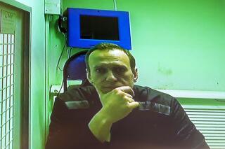 FILE - Russian opposition leader Alexei Navalny is seen on a TV screen, as he appears in a video link provided by the Russian Federal Penitentiary Service in a courtroom of the Second Cassation Court of General Jurisdiction in Moscow, Russia, Tuesday, Oct. 18, 2022. Russia's most prominent opposition leader has lost another court fight to protest his prison conditions. A judge in the Vladimir regional city of Kovrov on Thursday, Nov. 10 dismissed Alexei Navalny's protest against his confinement in a punishment cell. (AP Photo/Alexander Zemlianichenko, File)
