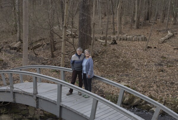 Jon Randall, left, and Mariane Randall, right, pose for a portrait at their home on Saturday, March 22, 2025, in Webster, N.Y. (Toni Duncan via AP)