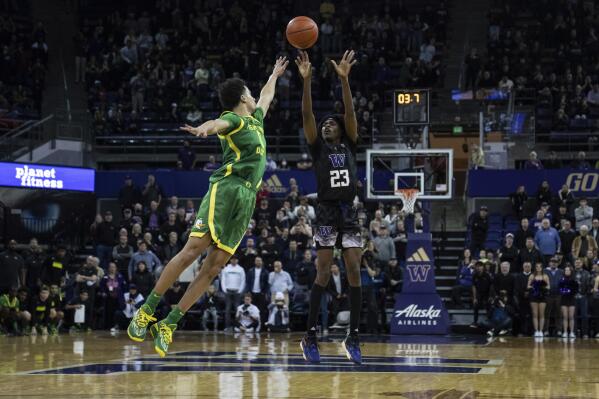 Washington guard Keyon Menifield shoots over Oregon guard Will Richardson during the second half of an NCAA college basketball game Wednesday, Feb. 15, 2023, in Seattle. (AP Photo/Stephen Brashear)