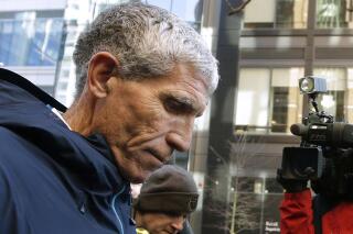 FILE - In this March 12, 2019, file photo, William "Rick" Singer, founder of the Edge College & Career Network, departs federal court in Boston after pleading guilty to charges in a nationwide college admissions bribery scandal. Singer, 62, who pleaded guilty in March 2019 to charges including racketeering conspiracy and money laundering conspiracy, is scheduled to sentenced on Wednesday in U.S. District Court in Boston for running the scheme that federal investigators dubbed Operation Varsity Blues. (AP Photo/Steven Senne, File)