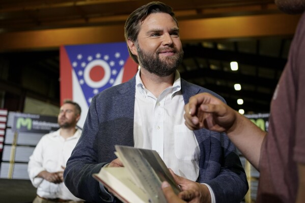 J.D. Vance, the venture capitalist and author of "Hillbilly Elegy," holds his book as he speaks with supporters after a rally on July 1, 2021, in Middletown, Ohio. (ĢӰԺ Photo/Jeff Dean, File)