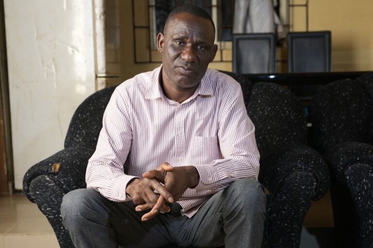 Pius Orofin, a deck operator aboard the Trinity Spirit oil ship, speaks during an interview at his home in Okitipupa, Nigeria, on Tuesday, Sept. 6, 2022. The Trinity Spirit’s surviving crew members have been plagued by ailments long after their escape from the fire. Orofin’s hearing is damaged, and he has a long scar on his leg. Not long after that vivid night, still in the throes of recovery, he and colleague Patrick Aganyebi were taken to jail for 19 days. (AP Photo/Sunday Alamba)