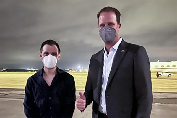 Trevor Reed, left, a Texas resident arrested in Russia in 2019, is greeted by Rep. August Pfluger, R-Texas, at a military airfield in Texas, Thursday, April 28, 2022.   (Jonathan Franks via AP)