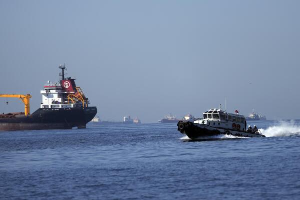 FILE - A boat with Russian, Ukrainian, Turkish and U.N. officials heads to inspect cargo ships coming from Ukraine loaded with grain, in the Marmara Sea in Istanbul, Turkey, Saturday, Oct. 1, 2022. The amount of grain leaving Ukraine has dropped even as a U.N.-brokered deal works to keep food flowing to developing nations, with inspections of ships falling to half what they were four months ago and a backlog of vessels growing as Russia's invasion nears the one-year mark. (AP Photo/Khalil Hamra, File)