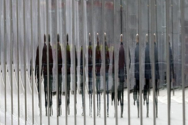 
              French police officers are reflected in the protective glass fence at the Eiffel Tower Monday, May 20, 2019 in Paris. The Eiffel Tower has been closed to visitors after a man has tried to scale it. (AP Photo/Michel Euler)
            