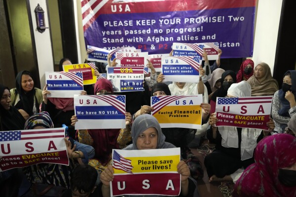 Afghan refugees hold an indoor rally to demand their U.S. visa to be processed in Islamabad, Pakistan, Friday, July 21, 2023. When the U.S. pulled out of Afghanistan in August 2021, it carried tens of thousands of Afghans to safety. But two years later, many others are still waiting to be resettled. Those are Afghans who helped the war effort by working with the U.S. government and military or Afghan journalists and aid workers whose former work puts them at risk under the Taliban. (AP Photo/Rahmat Gul)