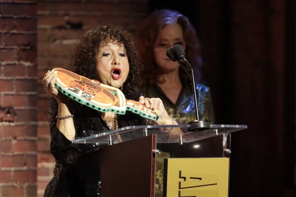 Maria Muldaur accepts the Trailblazer Award after it was presented to her by Bonnie Raitt, right, at the Americana Honors & Awards show Wednesday, Sept. 11, 2019, in Nashville, Tenn. (AP Photo/Wade Payne)