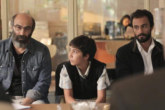 This image provided by Amazon Studios shows Mohsen Tanabandeh, from left, Saleh Karimai and Amir Jadidi in a scene from "A Hero." (Amazon Studios via AP)