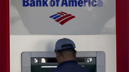 File - A customer uses an ATM at a Bank of America location in San Francisco, Monday, April 24, 2023. Bank of America is being ordered to pay more than $100 million to customers for double-dipping on some fees imposed on customers, withholding reward bonuses explicitly promised to credit card customers, and misappropriating sensitive personal information to open accounts without customer knowledge or authorization. (AP Photo/Jeff Chiu, File)