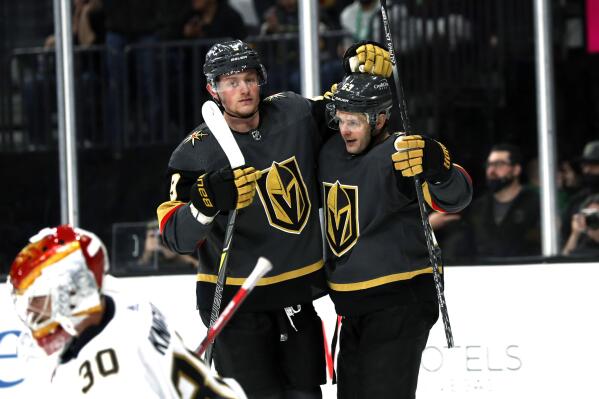 Vegas Golden Knights right wing Evgenii Dadonov, right, celebrates with center Jack Eichel (9) after scoring against Florida Panthers goaltender Spencer Knight (30) during the second period of an NHL hockey game Thursday, March 17, 2022, in Las Vegas. (AP Photo/Steve Marcus)