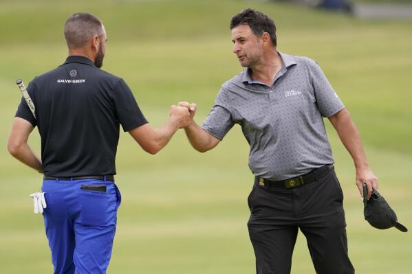 Richard Bland, of England, right, fist bumps Troy Merritt after their round on the ninth green during the second round of the U.S. Open Golf Championship, Friday, June 18, 2021, at Torrey Pines Golf Course in San Diego. (AP Photo/Jae C. Hong)