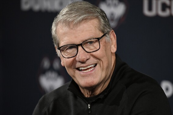 FILE - UConn coach Geno Auriemma smiles after gaining his 1,200th career win, following the team's NCAA college basketball game against Seton Hall Wednesday, Feb. 7, 2024, in Hartford, Conn. The U.S. Basketball Writers Association announced Wednesday, April 17, 2024, that it will name its annual women’s national coach of the year award after UConn's Geno Auriemma. (AP Photo/Jessica Hill, File)