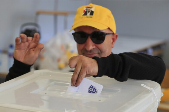 A Hezbollah member who was wounded during Sept. 17, 2024 pager explosions, casts his vote at a polling station during municipal elections in the town of Nabatieh, south Lebanon, Saturday, May 24, 2025. (AP Photo/Mohammed Zaatari)