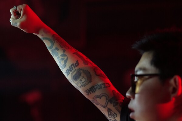 A Chinese band member raises his clenched fist during a punk festival in Hangzhou, China, Friday, Jan. 17, 2025. (AP Photo/Aaron Favila)