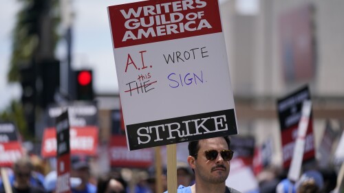 FILE - Members of the The Writers Guild of America picket outside Fox Studios on Tuesday, May 2, 2023, in Los Angeles. Getting control of the use of artificial intelligence is a central issue in the current strikes of Hollywood's actors and writers, which on Friday, July 21, 2023, entered its second week. (AP Photo/Ashley Landis, File)