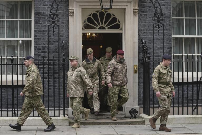 Ukrainian Armed Forces and representatives from each Interflex nation, arrive for a minute's silence to mark the one-year anniversary of the full-scale Russian invasion of Ukraine, at the Downing Street, in London, Friday, Feb. 24, 2023. (AP Photo/Kin Cheung)