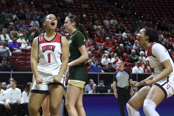 UNLV forward Nneka Obiazor (1) celebrates with teammate forward Alyssa Brown, right, after scoring a basket and drawing a foul in the first half of an NCAA college basketball game in the semifinals of the Mountain West Conference tournament, Tuesday, March 12, 2024, in Las Vegas. (Steve Marcus/Las Vegas Sun via AP)