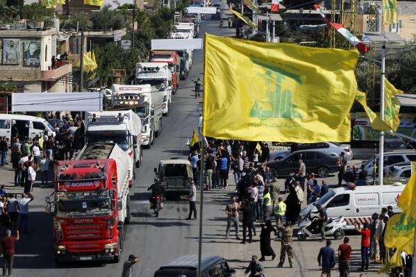 A convoy of tanker trucks carrying Iranian diesel crossed the border from Syria into Lebanon, arrive at the eastern town of el-Ain, Lebanon, Thursday, Sept. 16, 2021. The delivery, organized by the Iranian-backed Hezbollah group, violates U.S. sanctions imposed on Tehran after former President Donald Trump pulled America out of a nuclear deal between Iran and world powers three years ago. (AP Photo/Bilal Hussein)