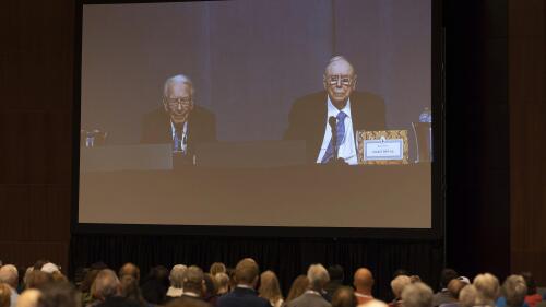 Stockholders watch Warren Buffett and Charlie Munger from the overflow room during Berkshire Hathaway's annual meeting Saturday, May 6, 2023, in Omaha, Neb.  (AP Photo/Rebecca S. Gratz)