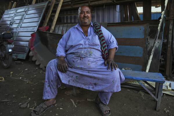 Artisan Muhammad Ashfaq, 55, sits for a portrait at his workshop in Rawalpindi, Pakistan, on Sunday, April 27, 2025. (AP Photo/Anjum Naveed)