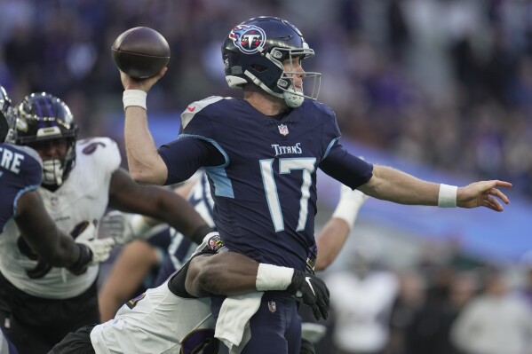 Tennessee Titans quarterback Ryan Tannehill (17) looks to throw a pass as he is pressured by a Baltimore Ravens' defender during the second half of an NFL football game Sunday, Oct. 15, 2023, at the Tottenham Hotspur stadium in London. (AP Photo/Kin Cheung)