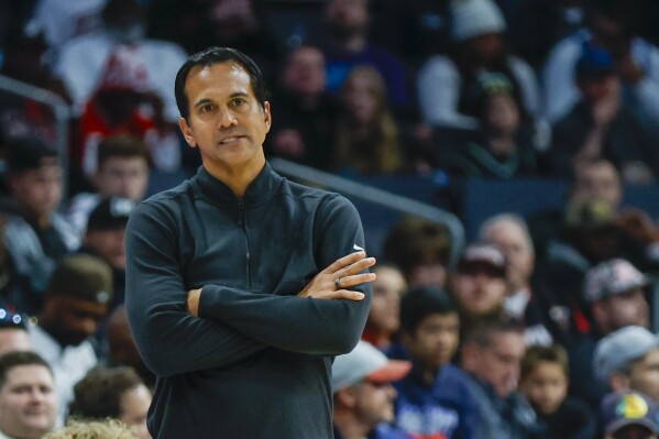 Miami Heat head coach Erik Spoelstra watches his team play against the Charlotte Hornets during the second half of an NBA basketball game in Charlotte, N.C., Monday, Dec. 11, 2023. (AP Photo/Nell Redmond)