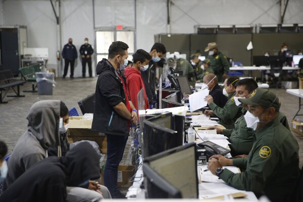 Migrants are processed at the intake area of the Donna Department of Homeland Security holding facility, the main detention center for unaccompanied children in the Rio Grande Valley, in Donna, Texas, Tuesday, March 30, 2021. (AP Photo/Dario Lopez-Mills,Pool)
