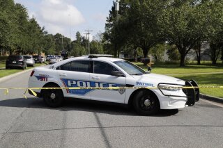 Tallahassee police investigate the scene of multiple stabbings, Wednesday, Sept. 11, 2019 in Tallahassee, Fla. A suspect stabbed at least five people at a building supply company in Florida's capital city before being taken into custody by police officers, authorities said. (Tori Schneider/Tallahassee Democrat via AP)