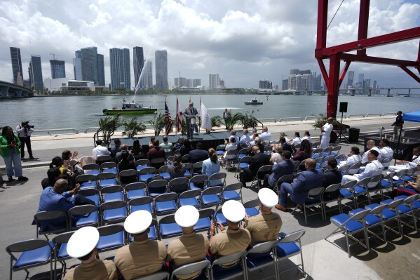 A Miami-Dade Fire Rescue boat sprays water as U.S. Secretary of the Navy Carlos Del Toro speaks during an event to announce that the Navy will hold its May 2024 Fleet Week in Miami, Friday, July 14, 2023, at PortMiami, in Miami. (AP Photo/Rebecca Blackwell)