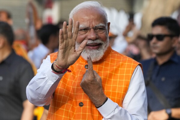 Indian Prime Minister Narendra Modi, shows the indelible ink mark on his index finger after casting his vote during the third phase of general elections, in Ahmedabad, Gujarat, India, Tuesday, May 7, 2024. (AP Photo/Ajit Solanki)