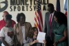 Michigan Gov. Gretchen Whitmer signs Crown Act legislation on Thursday, June 15, 2023 in Lansing, Mich. that will outlaw race-based hairstyle discrimination in workplaces and schools. State Sen. Sarah Anthony, far right, has pushed for the legislation since 2019. (AP Photo/Joey Cappelletti)