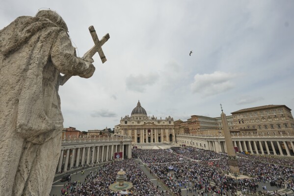 Pope Leo XIV appears at the central balcony of St. Peter's Basilica for his first Sunday blessing after his election, in St. Peter's Square at the Vatican, Sunday May 11, 2025. (AP Photo/Alessandra Tarantino)
