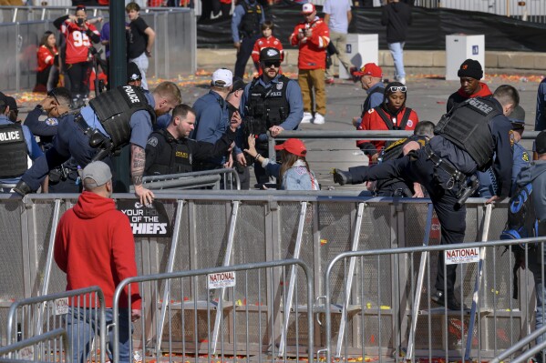 Law enforcement personnel investigate following a shooting at the Kansas City Chiefs NFL football Super Bowl celebration in Kansas City, Mo., Wednesday, Feb. 14, 2024. Multiple people were injured, a fire official said.(AP Photo/Reed Hoffmann)