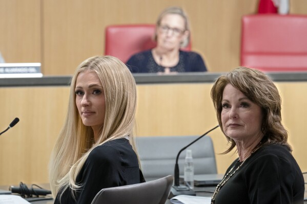 Hotel heiress and media personalty Paris Hilton, left, and state Sen. Shannon Grove, R-Bakersfield right, listen as supporters speak in support Grove's proposed bill calling on more transparency for youth treatment facilities licensed by the California Department of Social Services, during a hearing of the Senate Human Services Committee in Sacramento, Calif., Monday, April 15, 2024. (AP Photo/Rich Pedroncelli)