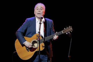 FILE - In a Sept. 22, 2016 file photo, musician Paul Simon performs during the Global Citizen Festival, in New York. Simon wraps up his farewell concert tour Saturday, Sept. 22, 2018 at a park in Queens, a bicycle ride across the borough from where he grew up. The 76-year-old singer picked Flushing Meadows Corona Park to say goodbye, an outdoor show on the first night of autumn. (AP Photo/Julie Jacobson, File)