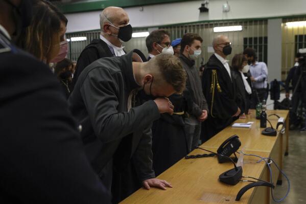 FILE - Finnegan Lee Elder, wipes his eye, as he and his co-defendant Gabriel Natale-Hjorth listen as the verdict is read, in the trial for the slaying of an Italian plainclothes police officer on a street near the hotel where they were staying while on vacation in Rome in summer 2019, in Rome, on May 5, 2021. The Court of Cassation late Wednesday, March 15, 2023, threw out the guilty verdicts against Lee Elder, now 23, and Natale-Hjorth, 22, both convicted in the stabbing death of the 35-year-old officer during a plainclothes operation while the Americans, teens at the time, were on vacation in Rome in the summer of 2019. (AP Photo/Gregorio Borgia, File)